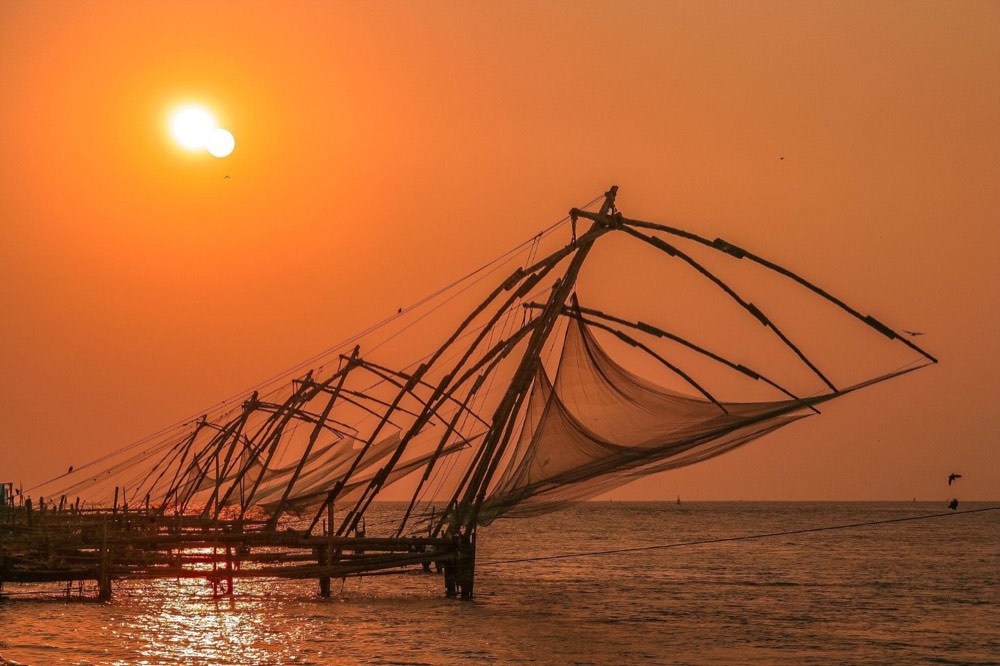 Chinese fishing nets silhouetted at sunset in Fort Kochi